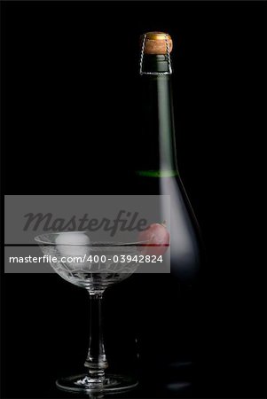 Champagne Botlte with a glass on a black background