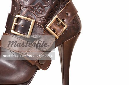 Female boot with fasteners on a high heel