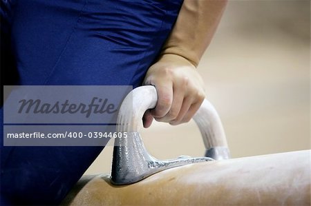 Closeup of a man competing on pommel