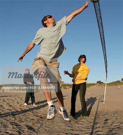 People playing volleyball on the beach