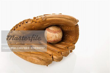 Baseball resting in baseball glove.