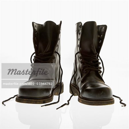 Black leather high top boots with untied laces.