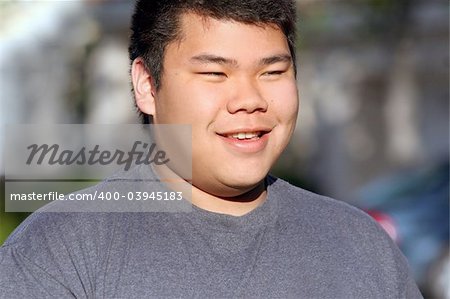 Asian teenager outdoors with blurred background