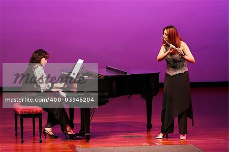 Flutist and pianist girls on stage