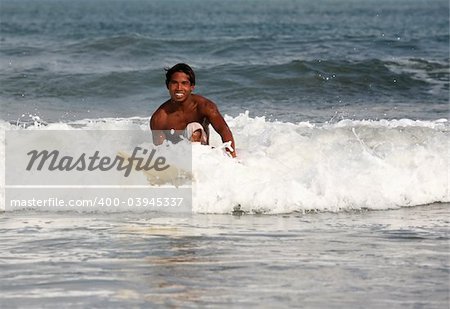 A surfer heading into the waves