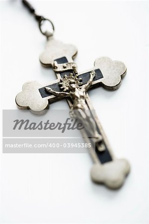 Christian rosary crucifix on white background.