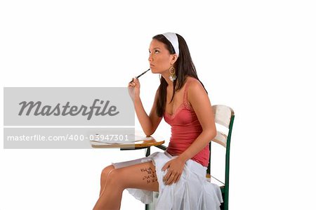 Female student taking exam using notes on her thigh