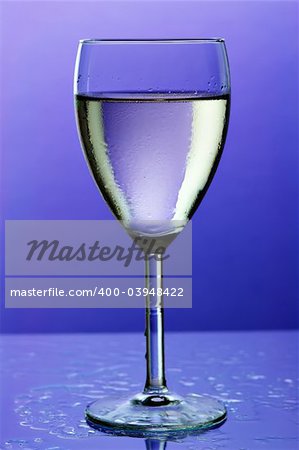 glass of wine on blue background