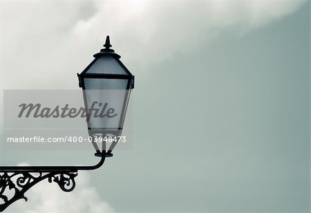 Old classic street lantern against the sky