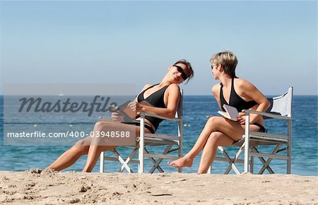 2 women reading on the beach