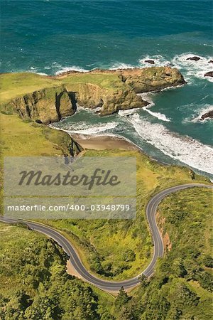 Aerial of winding road Shoreline Highway on west coast with Pacific Ocean in California, USA.