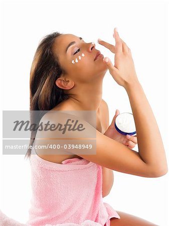 cute young girl with cream on face and on the nose