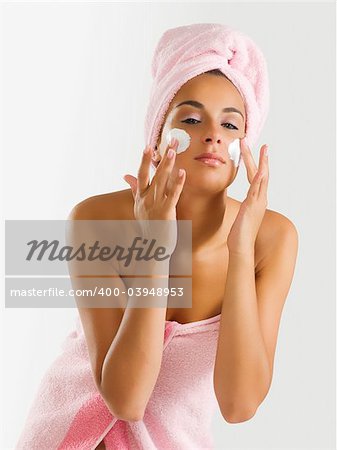 nice girl with pink towel and cream on her face and a turban