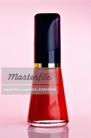 Red Nail polish on pink background