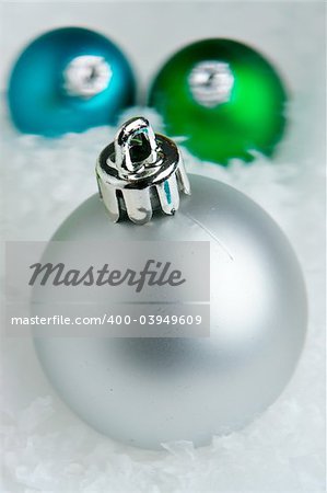Macro of christmas baubles on white snow
