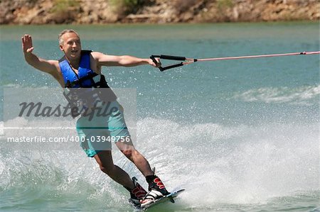 Middleage man wakeboarding