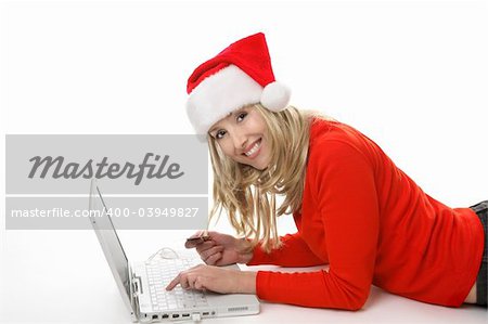 A female using a laptop and shopping online buying  gifts at Christmastime.