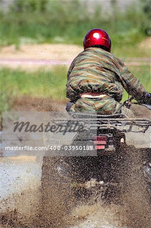 The racer in a helmet on a motor tricycle