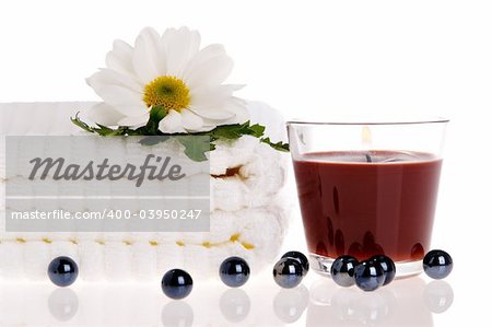 Towels, candle, and daisy on white isolated