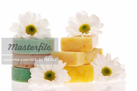 Soap bars and daisies isolated on white