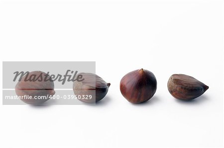 Four chestnuts isolated on white