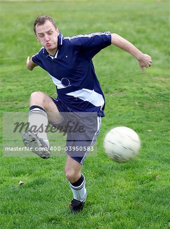 Soccer player hitting a ball