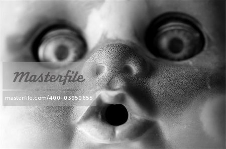 Close up of a dirty doll face in black and white