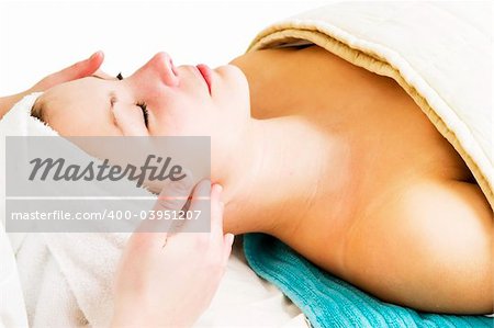 A woman receiving a facial massage at a beauty spa.