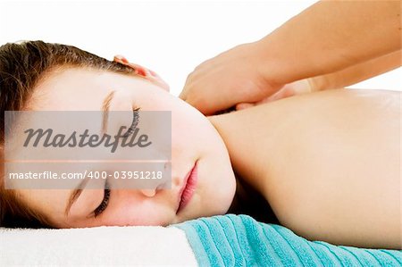 A young female receives a shoulder massage at a spa