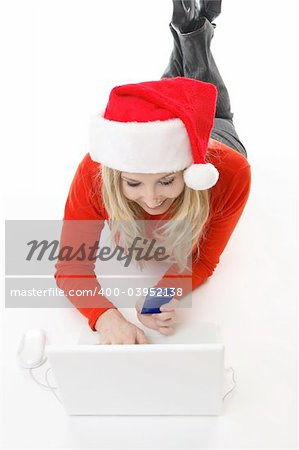 A girl using a card and laptop makes an online purchase from an e-tailer or makes an internet bill payment or other financial transaction