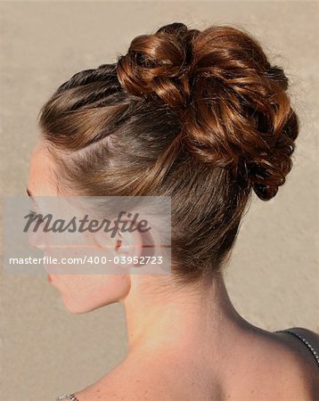 young woman and her beautiful hairstyle for ceremony