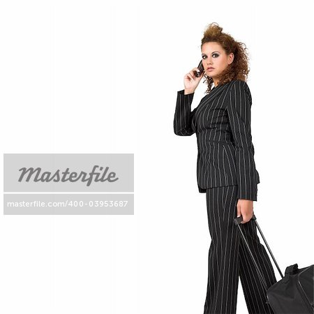 Businesswoman pulling her luggage, isolated on white background; copy space.