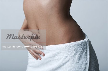 Beautiful womans body part wearing white towel on clear background