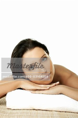 Portrait of Fresh and Beautiful brunette woman laying on bamboo mat