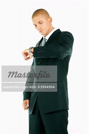 A Young businessman looking at his hand watch