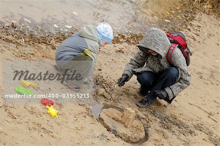 Child playing with his mother on shore/bank