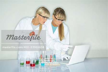 Beautiful female lab workers testing and experimenting