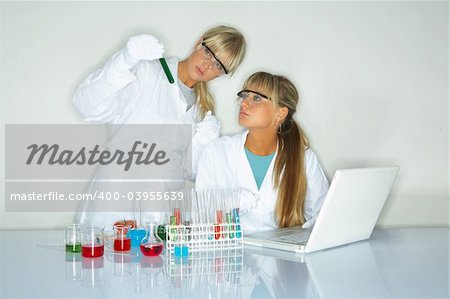 Beautiful female lab workers testing and experimenting