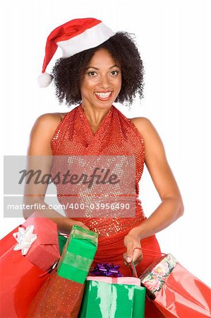 Attractive tanned female in Santa hat with bags full of gifts