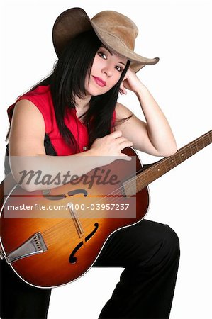 A woman in western clothing rests casually with a guitar.