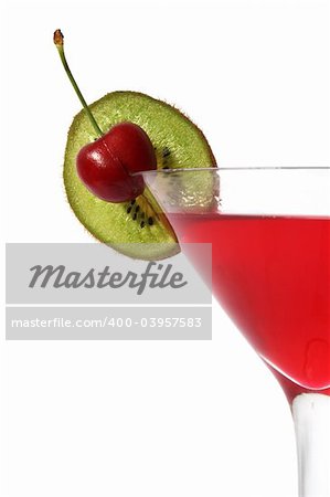 Close up of red cocktail with cherry and kiwi slice garnish; over white