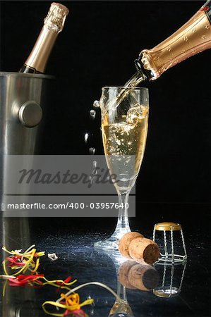 Pouring a champagne flute for celebration time. (with confetti)