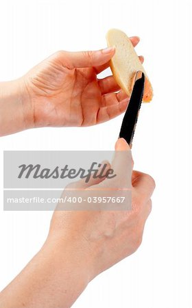 Buttering slice of bread (clipping path) on white background