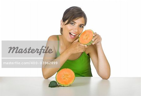Beautiful young woman eating a cantaloupe