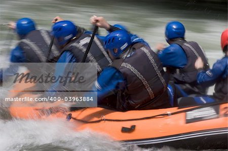 Whitewater rafting on a mountain river. With tripod and long exposure time - motion blurred.
