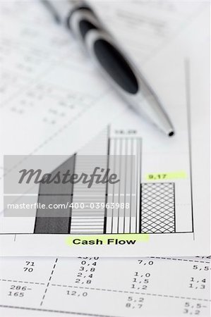 Business papers with ballpen focus on the words cash flow