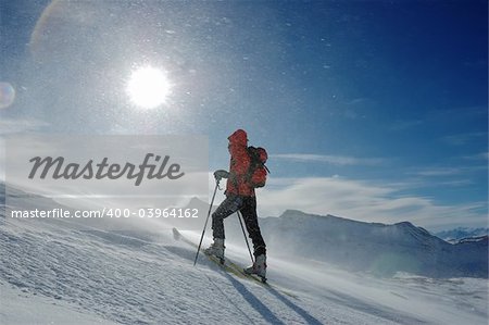 A lonely backcountry skier in snowstorm, horizontal orientation