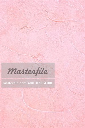 Light pink plaster with a deep relief on a wall
