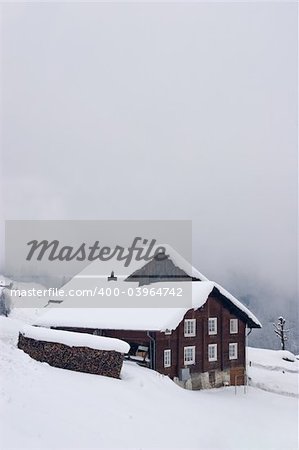 A typical Swiss house covered with snow, in the Alps. A typical Swiss house covered with snow, in the Alps.