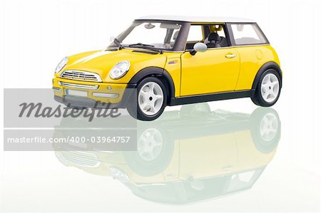 Yellow car with reflection. Studio shot.